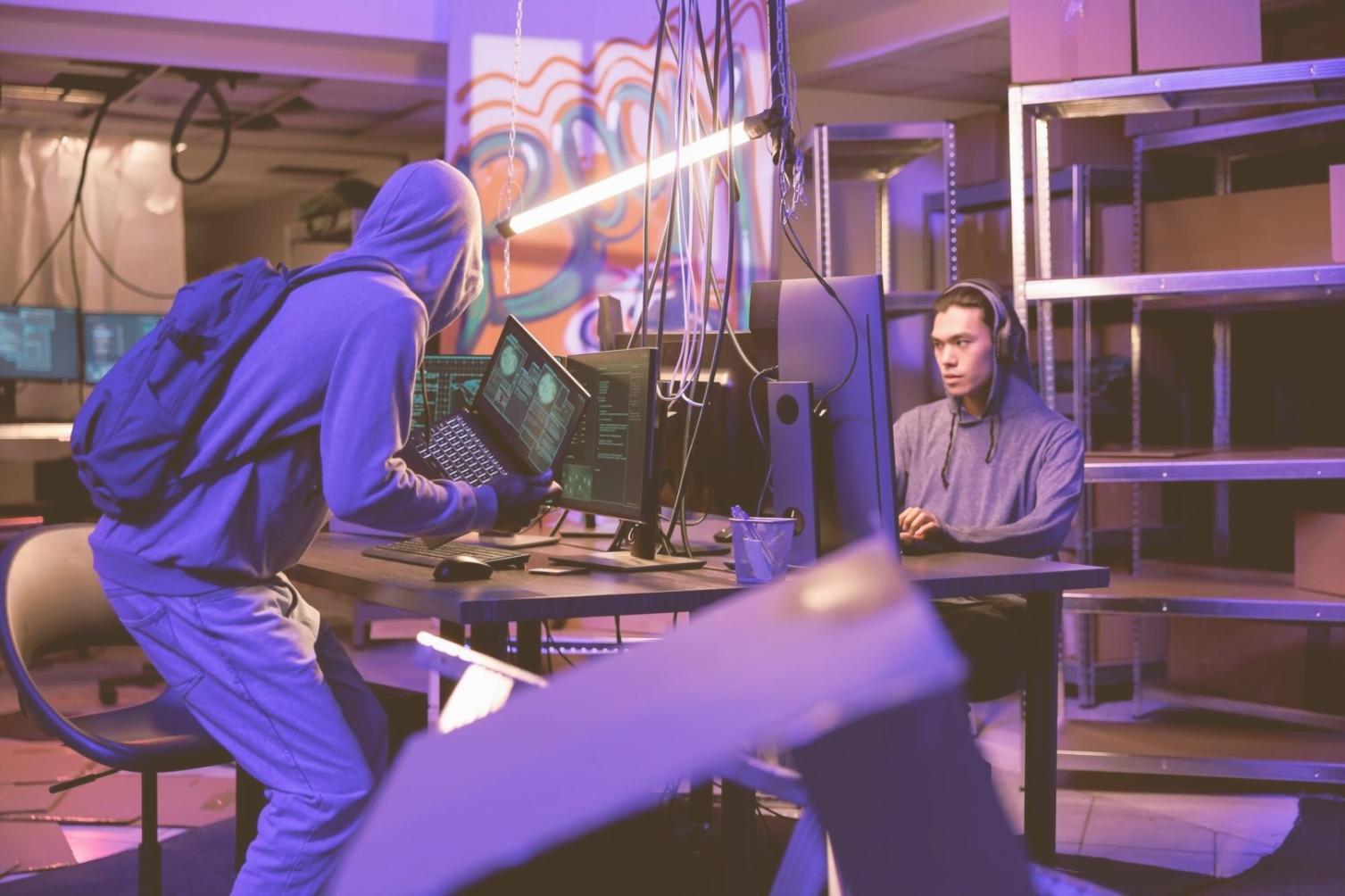 Developer analyzing performance metrics on multiple screens with VR headset nearby